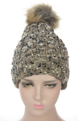 Taupe textured beanie with fleece lining and fur pom pom, perfect for stylish winter warmth and comfort.
