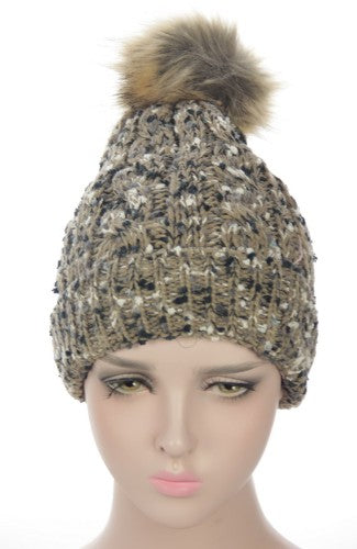 Taupe textured beanie with fleece lining and fur pom pom, perfect for stylish winter warmth and comfort.