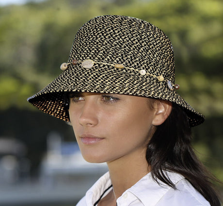 Navy Bohemian bucket sun hat with adjustable size, bead and shell trim, and PF 50+ UV protection for stylish sun safety.