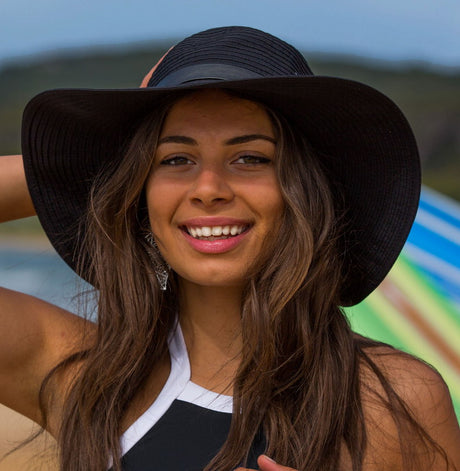 Stylish black braided capeline sun hat with adjustable size and UV protection, featuring a chic faux leather belt trim.