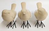 Set of 3 elegant white bird ornaments with turned heads, perfect for enhancing home decor and adding natural charm.