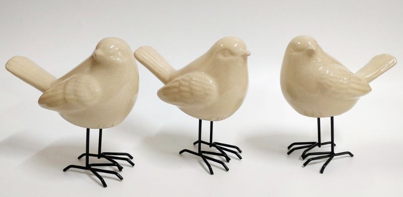 Set of 3 elegant white bird ornaments with turned heads, perfect for enhancing home decor and showcasing nature's beauty.