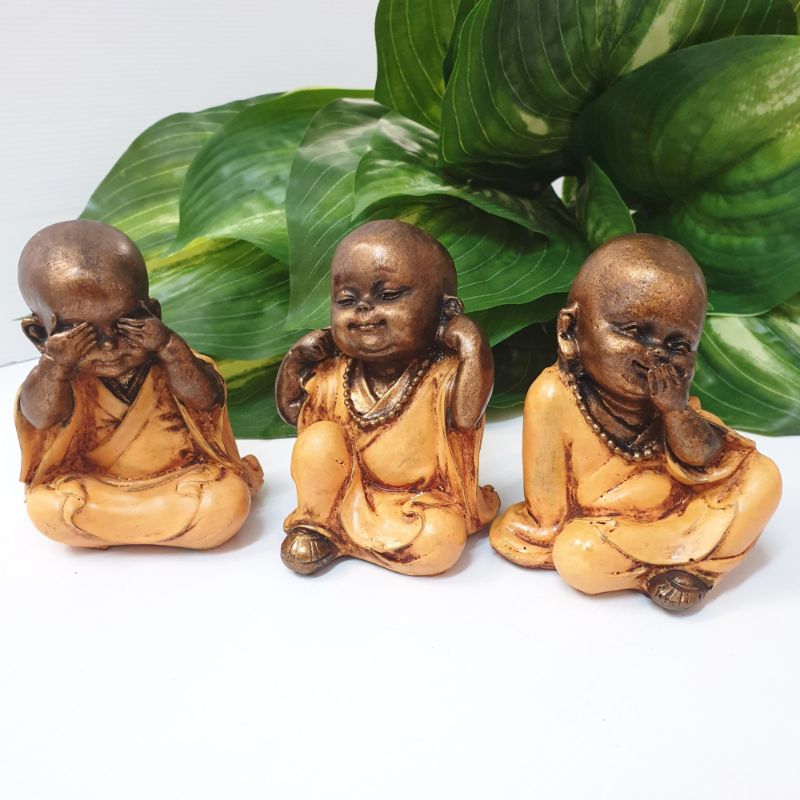 Vibrant orange ornament featuring three wise monkeys symbolizing see, hear, speak no evil, perfect for mindful decor.