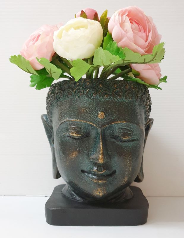 Serene Buddha face plant holder in green, 20cm, perfect for indoor plants, adding tranquility and style to any space.