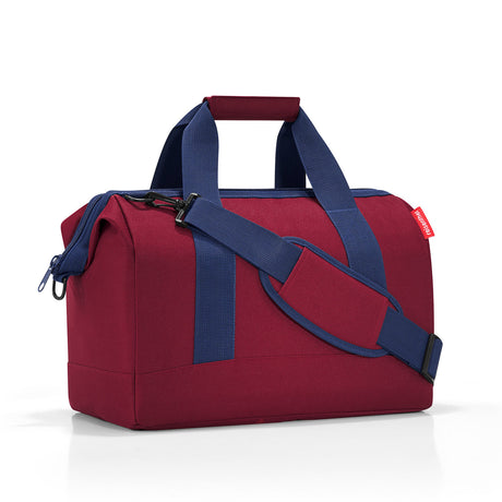 Versatile Reisenthel All Rounder M Bag in Dark Ruby, designed with 6 pockets, zip closure, and water-repellent fabric for everyday use.