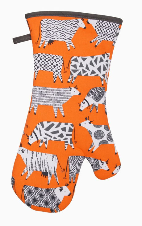Oven mitt featuring whimsical cow design, crafted by Ulster Weavers, known for high-quality kitchen textiles.