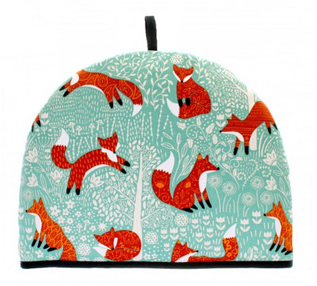 Whimsical Ulster Weavers tea cosy featuring a foraging fox design on a duck egg shell background, keeping tea warm in style.