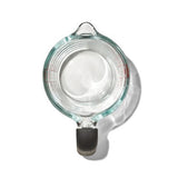 Clear glass measuring cup with non-slip handle and dripless spout, perfect for precise measuring and heating.