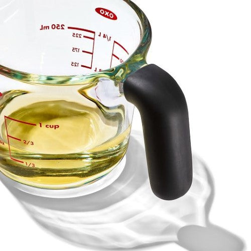 Glass measuring cup with clear markings, dripless spout, and non-slip handle; ideal for accurate measuring and easy pouring.