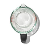 2-cup OXO Good Grips glass measuring cup with easy-to-read markings, dripless spout, and silicone lid for versatile kitchen use.