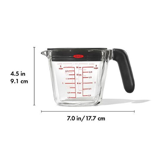 2-cup glass measuring cup with silicone lid, featuring easy-to-read markings and a spout for mess-free pouring.