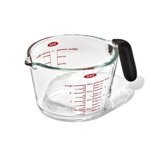 Durable OXO Good Grips 4-Cup Glass Measuring Cup with dripless spout, non-slip handle, and silicone lid for easy pouring.