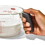 OXO Good Grips 4-Cup Glass Measuring Cup with dripless spout, silicone lid, and easy-to-read measurement markings.