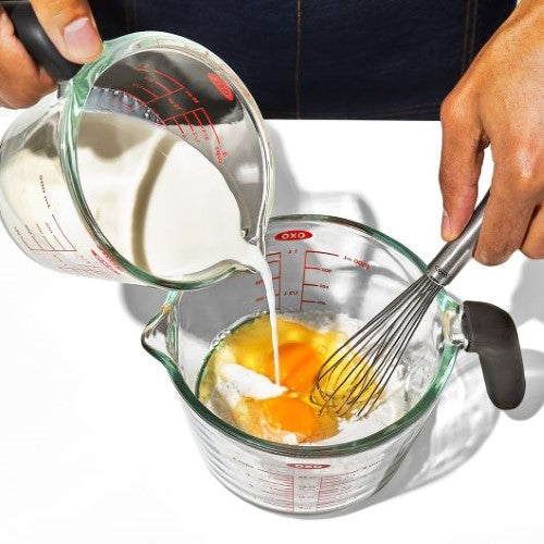 4-cup OXO Good Grips glass measuring cup with dripless spout, silicone lid, and thermal shock resistance for versatile cooking.