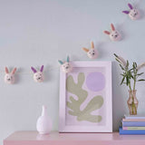 Whimsical fabric bunting featuring 8 charming felted bunny heads, perfect for festive occasions and children's parties.