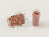 Edible glitter in vibrant apricot hue, perfect for cake decorating and enhancing desserts with a shimmering touch.
