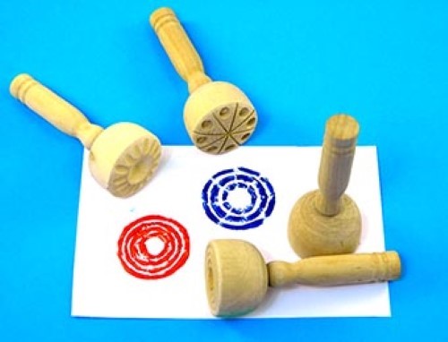 Wooden stampers set for kids, featuring 4 unique designs for creative play with dough, clay, and paint. Non-toxic and durable.