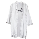 Luxurious white hen party dressing gown with 'Bride' in black stitching, perfect for pre-wedding celebrations.