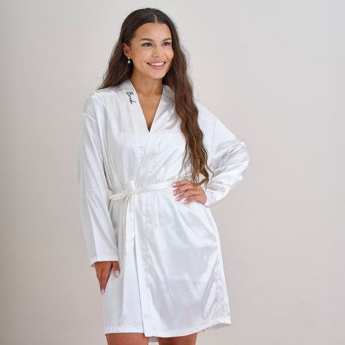 Luxurious white bride dressing gown with 'Bride' embroidered in black, perfect for hen parties and pre-wedding celebrations.