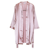 Luxurious pink satin bridesmaid dressing gown with elegant black embroidery, perfect for hen parties and bridal preparation moments.