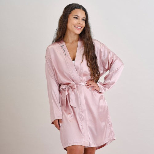 Pink satin bridesmaid dressing gown with 'bridesmaid' embroidery, perfect for hen parties and pre-wedding photos.