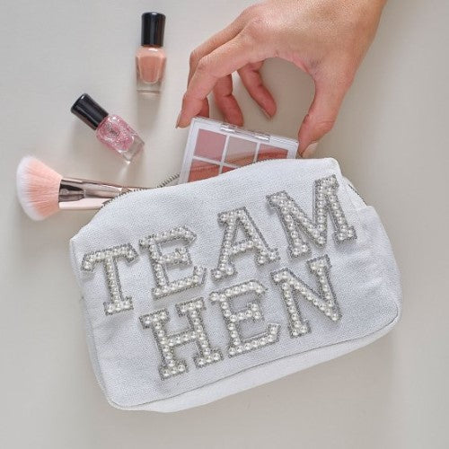 White cotton cosmetic bag with 'Team Hen' in pearls, perfect for hen parties, measures 20cm x 12cm with silver zipper.