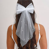 Elegant white tulle bow adorned with pearls, perfect for hen party celebrations and stylish group photos.