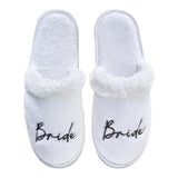 White fluffy Bride slippers with black embroidery, perfect for hen parties and pre-wedding celebrations.