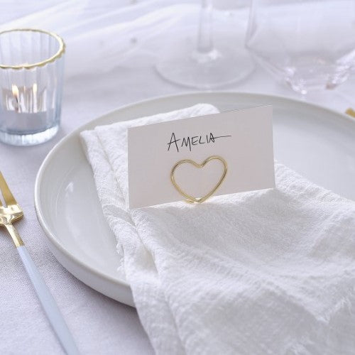 Elegant champagne gold metal wire place card holders, perfect for weddings and dinner parties, with white textured cards included.