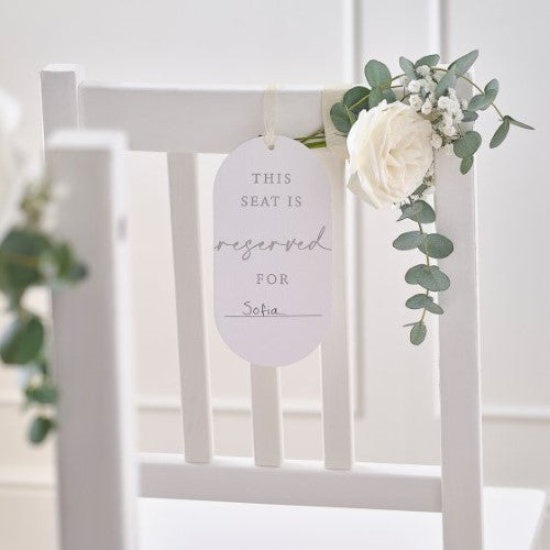 Pack of 10 elegant chair signs for events, featuring "This seat is reserved for..." with light taupe ribbons for easy display.