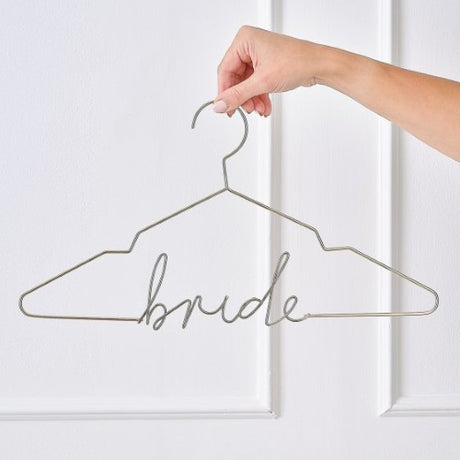 Elegant gold bride hanger designed for displaying wedding dresses, adding sophistication to bridal preparations and photos.