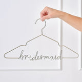 Modern gold bridesmaid hanger designed for elegant wedding dress displays and personalized keepsakes.