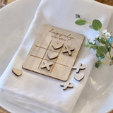 Charming wooden noughts and crosses game with 'Happily Ever After' engraving, perfect for romantic gatherings and decor.