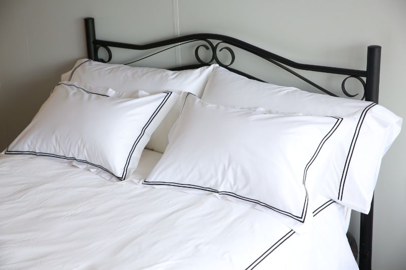 Elegant black queen duvet cover set with double festoon design, includes duvet cover and two matching pillowcases.