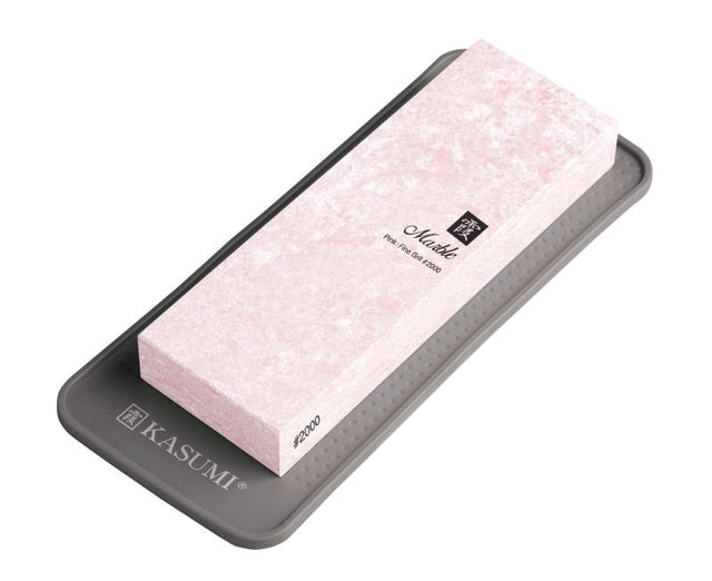 Pink marble Kasumi whetstone with 2000 grit for polishing knives, featuring a rubber base for stability and safety.