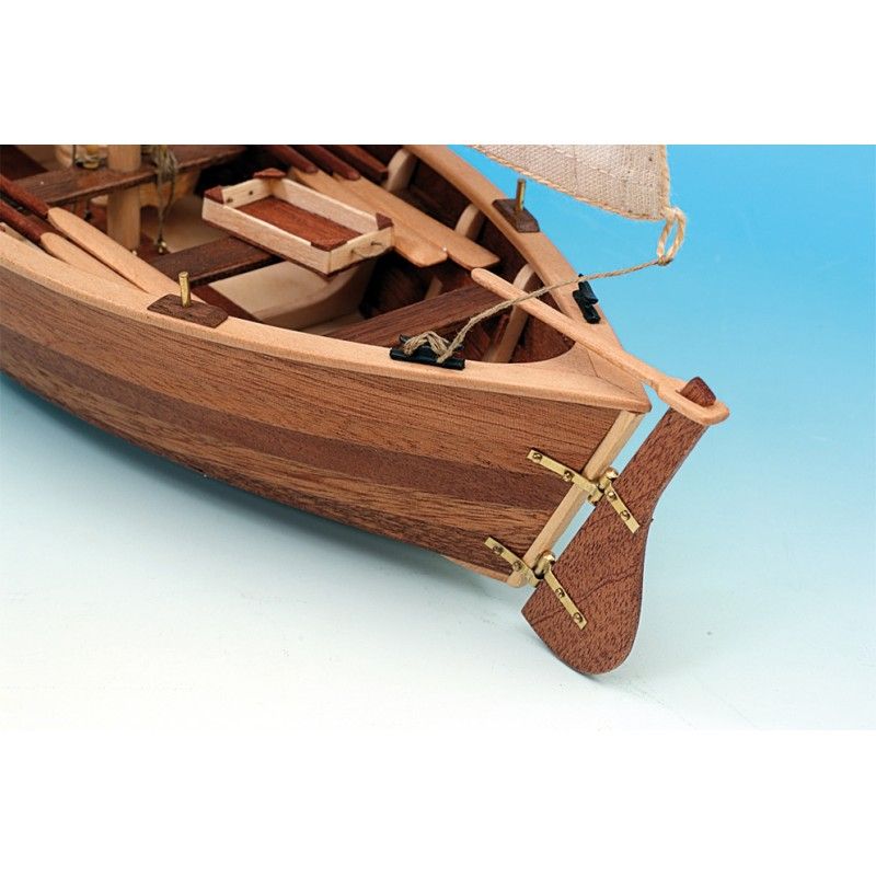 Detailed model ship kit featuring precision laser-cut woods, brass fittings, and hand-sewn cotton sails, capturing traditional elegance.