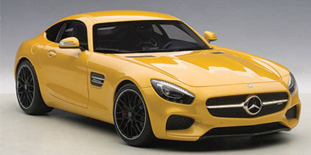 Diecast model of a yellow Mercedes-Benz AMG GT S, showcasing intricate details and luxury craftsmanship at 1/18 scale.