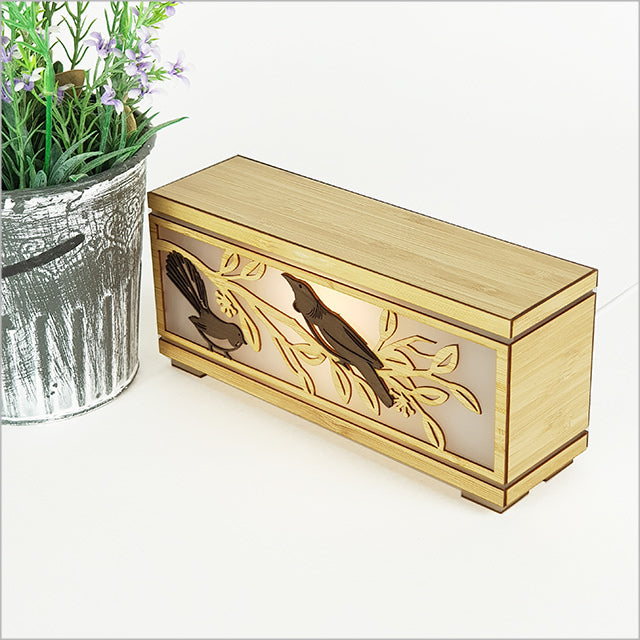 Eco-friendly LED Tealight Box featuring Tui and Fantail designs, perfect nightlight with warm glow and USB power.