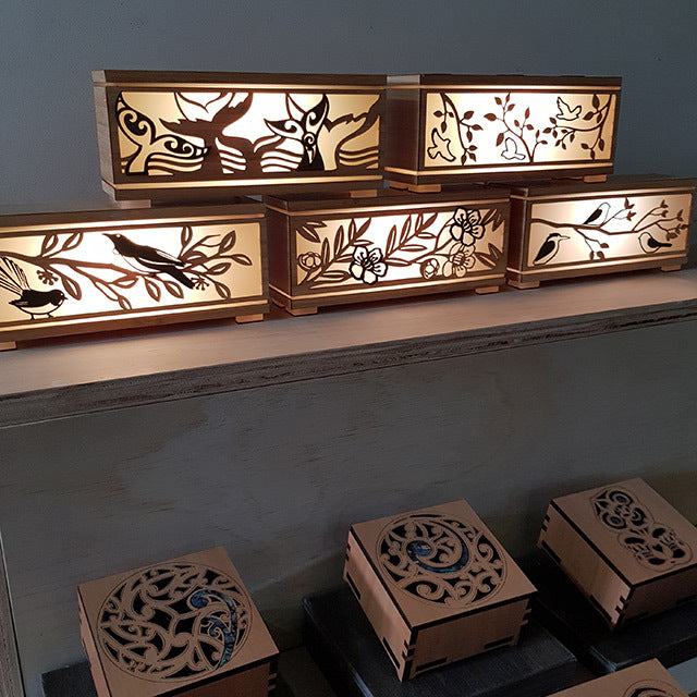 LED Tealight Box featuring Tui and Fantail designs, crafted from eco-friendly bamboo, providing soft, warm lighting.