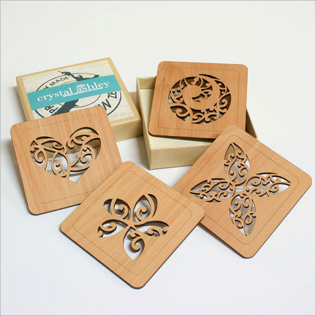 Handcrafted rimu wood coasters with intricate Kowhaiwhai designs, combining beauty and functionality for elegant home decor.