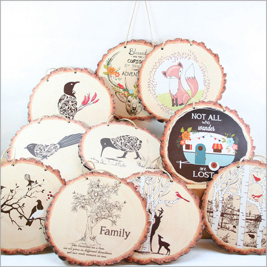 Colorful wood slice wall art featuring playful dinosaur designs, perfect for a child's room or nursery.