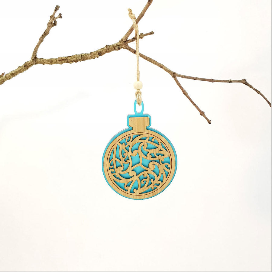 Teal satin acrylic hanging ornament with laser-cut bamboo design, perfect for festive decorating and thoughtful gifting.