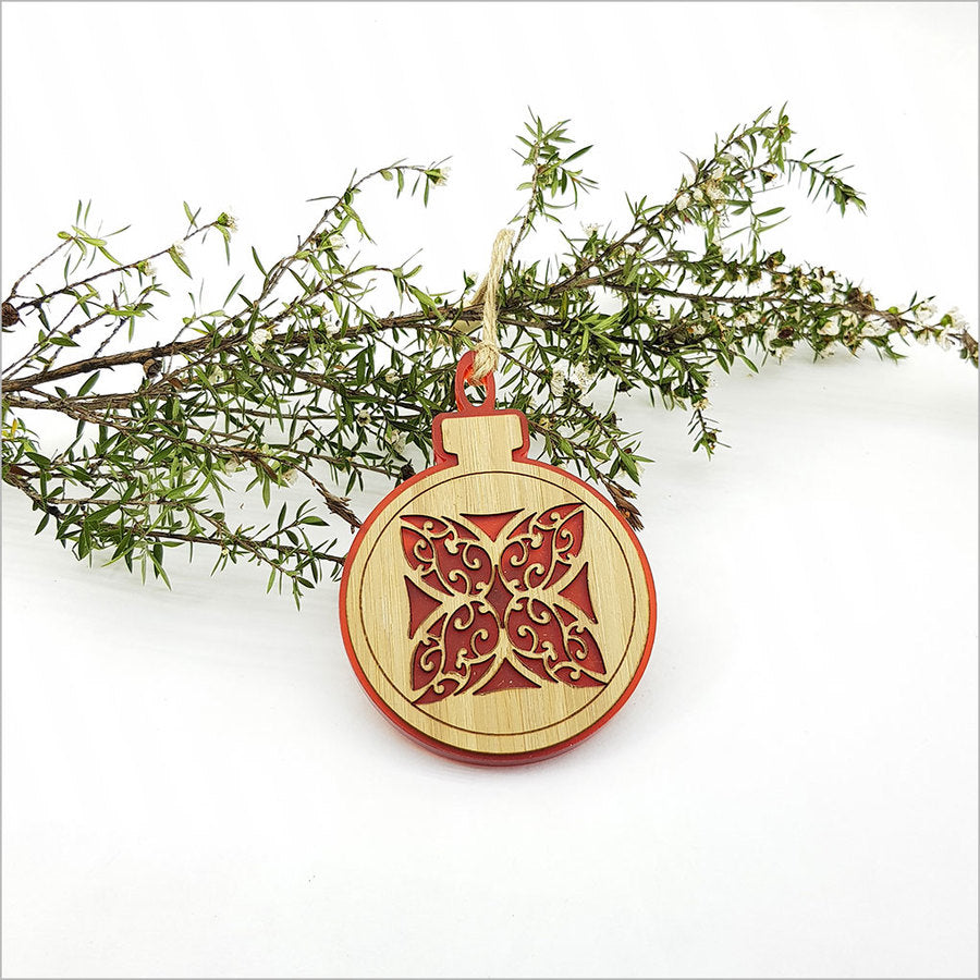 Red satin acrylic bauble ornament featuring a delicate laser-cut flower design, perfect for holiday decor or gifts.