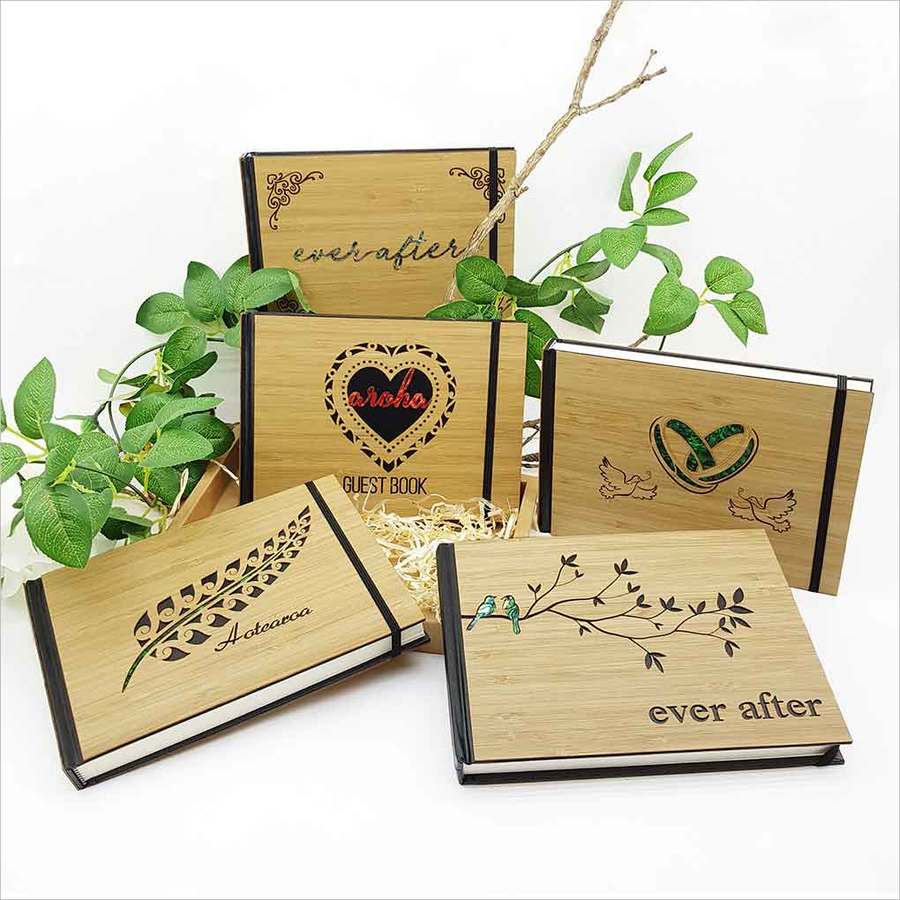 A small hardbound guest book journal featuring laser-cut bamboo and paua, ideal for preserving memories and sentiments.