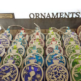 Teal acrylic bauble ornament featuring a fantail on a kowhai branch, perfect for home decor and gift-giving.