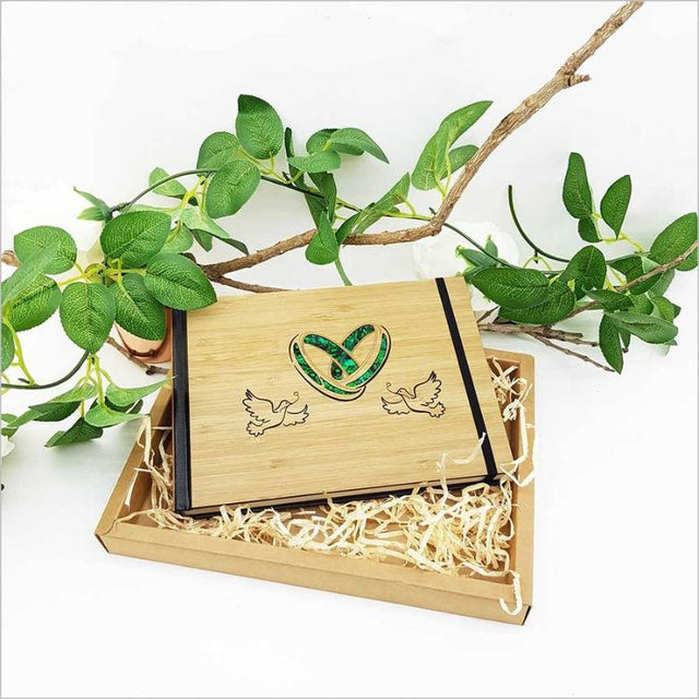 Elegant small guest book featuring laser-cut bamboo and paua, perfect for notes, sketches, or photos, 128 acid-free pages.