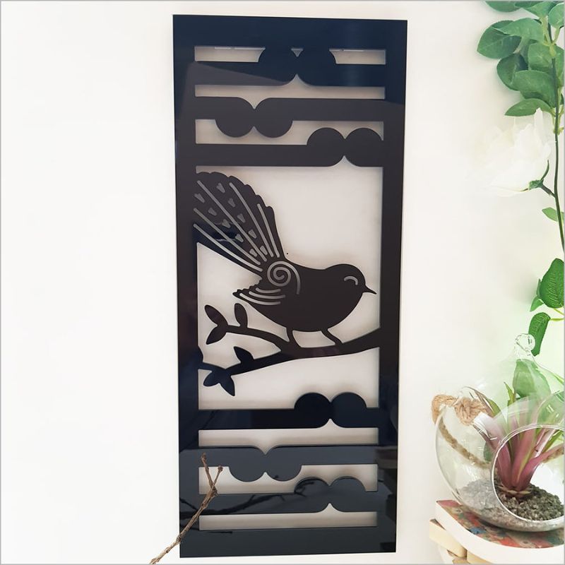 Stylish black wall art panel featuring Fantail and Koru motifs, perfect for indoor or outdoor decor. Size 230mm x 550mmH.