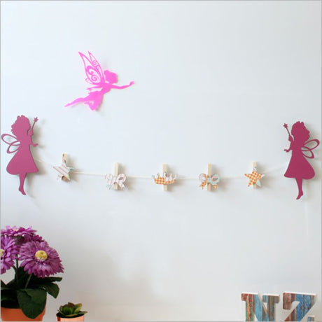 Delightful fairy-themed pegs for hanging kids' artwork, photos, and personalized messages in a whimsical display.