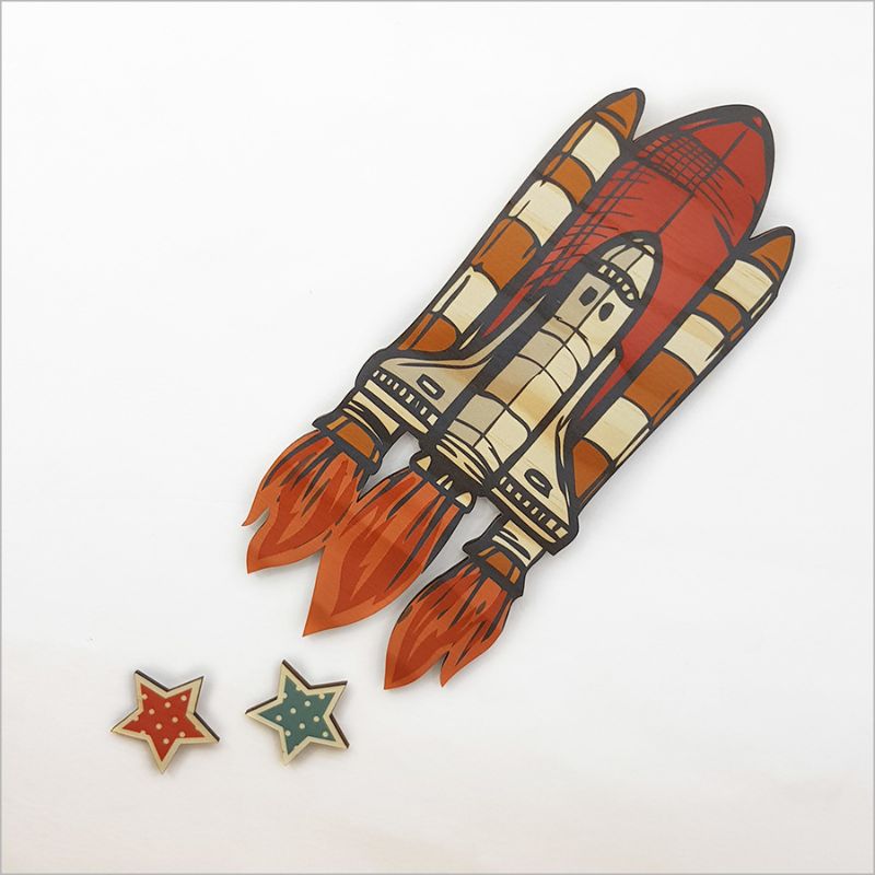 Eco-friendly pine veneer wall art featuring a 27cm space shuttle and two decorative stars for adventurous room decor.