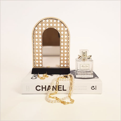 Elegant rattan arch earring stand with mirror, perfect for organizing and showcasing your jewelry collection.